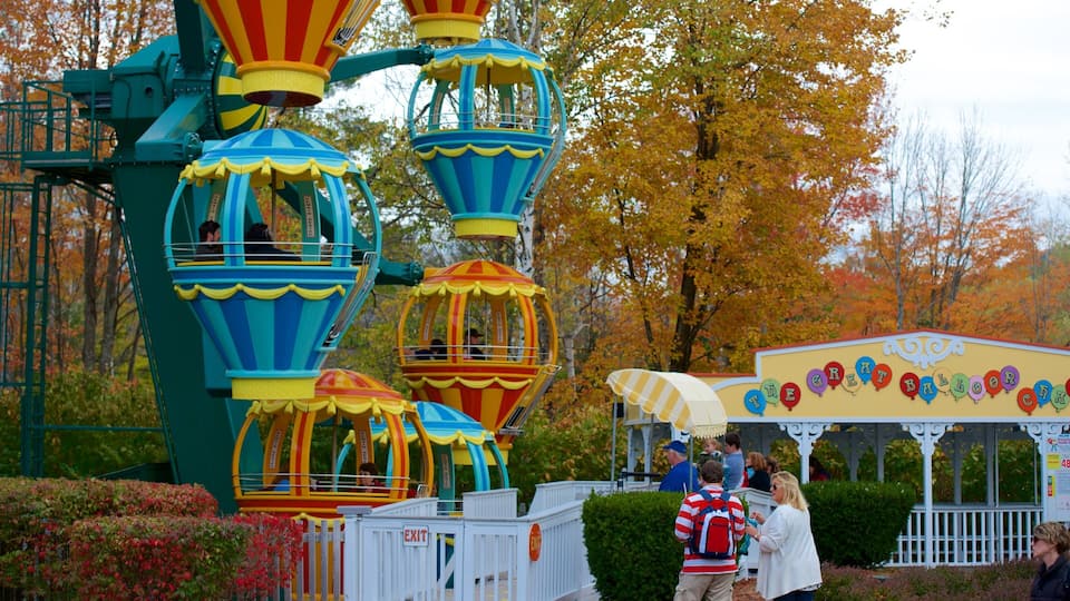A carousel with colorful hot air balloons, surrounded by autumn trees.