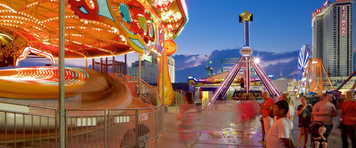 Steel Pier showing rides and night scenes as well as a small group of people
