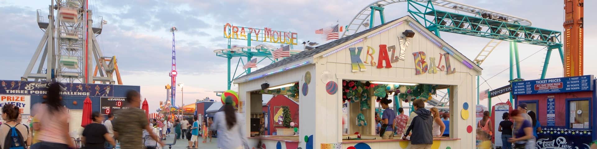 A bustling amusement park with rides like 'KRAZY BALL' and 'PRIZE CHALLENGE'.