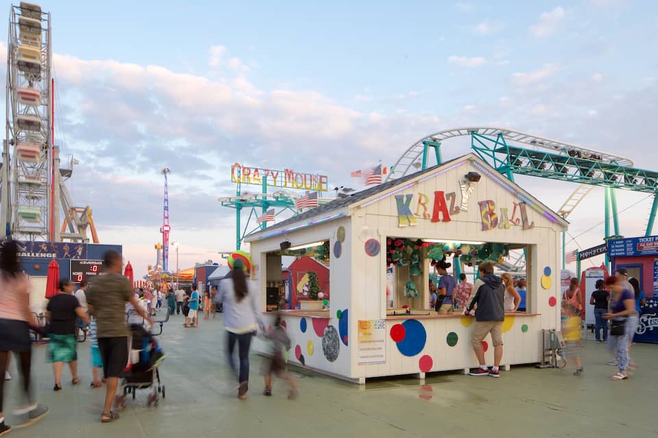 A bustling amusement park with rides like 'KRAZY BALL' and 'PRIZE CHALLENGE'.