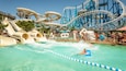 A water park with multiple water slides and a large roller coaster.