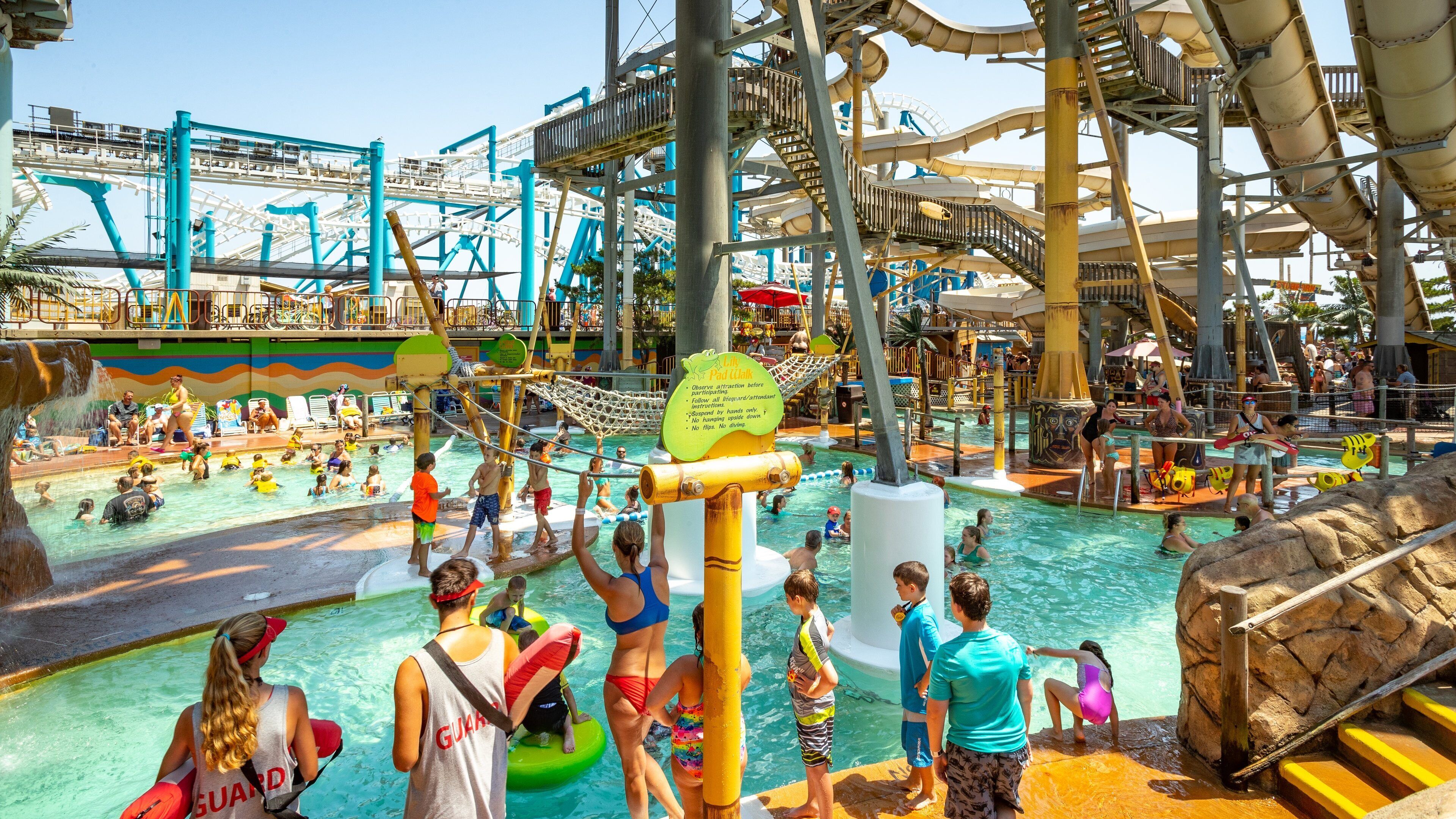 Ocean Oasis Waterpark and Beach Club featuring a waterpark and swimming as well as a large group of people