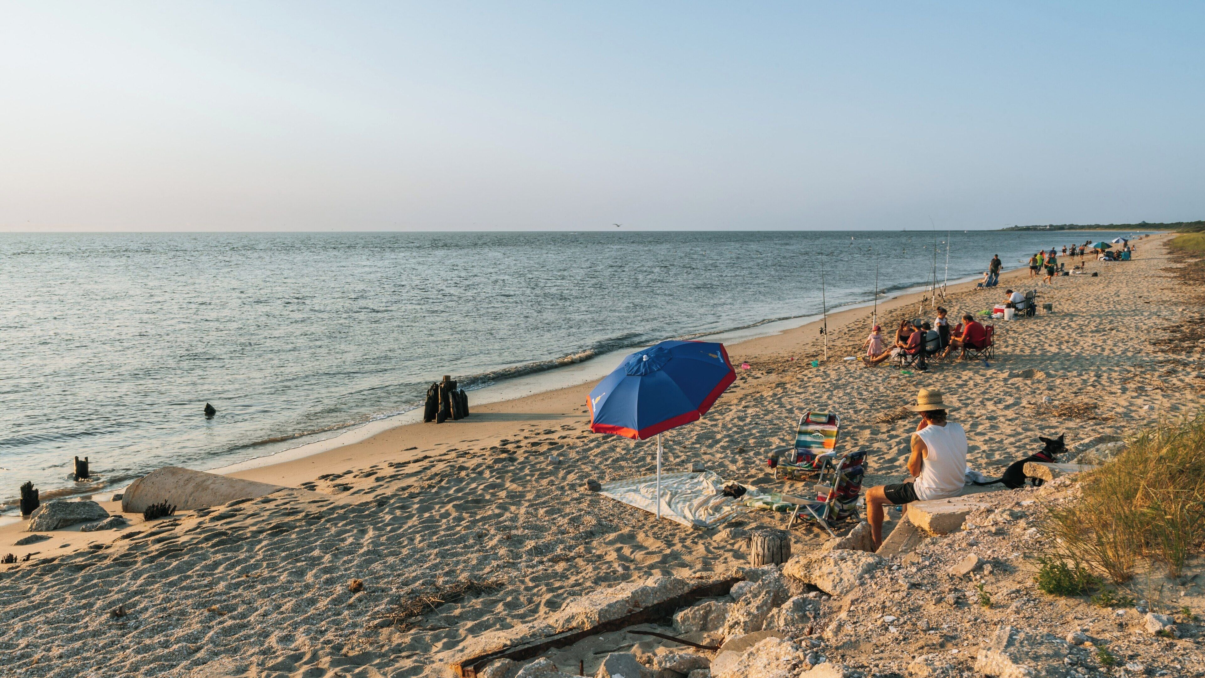 Enjoying a warm evening at Sunset Beach in Cape May, New Jersey with families, fishing, and beautiful ocean views
