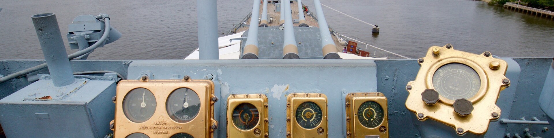 Battleship New Jersey featuring a marina, military items and a city