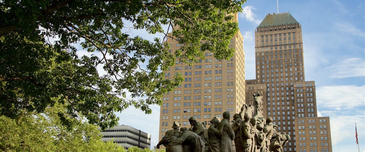 Military Park which includes a high rise building, a statue or sculpture and a city