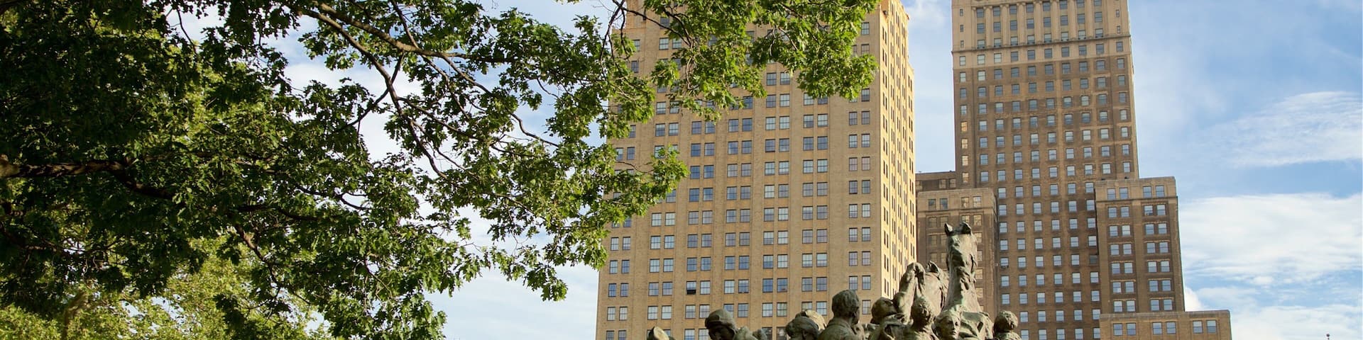 Military Park which includes a high rise building, a statue or sculpture and a city