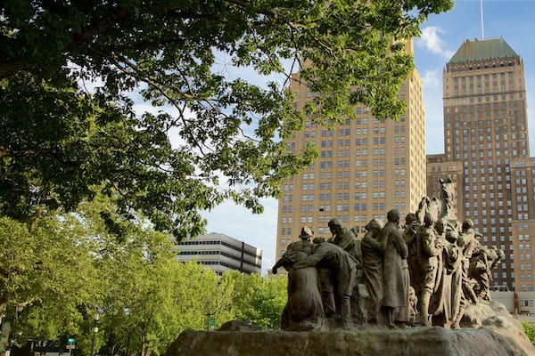 Military Park which includes a high rise building, a statue or sculpture and a city