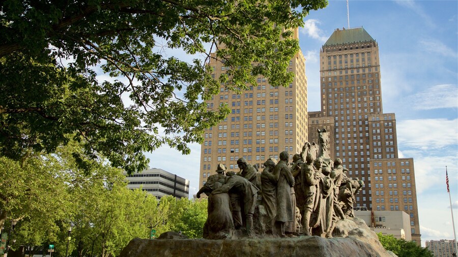 Military Park which includes a high rise building, a statue or sculpture and a city