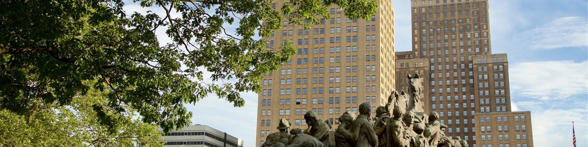 Military Park which includes a high rise building, a statue or sculpture and a city