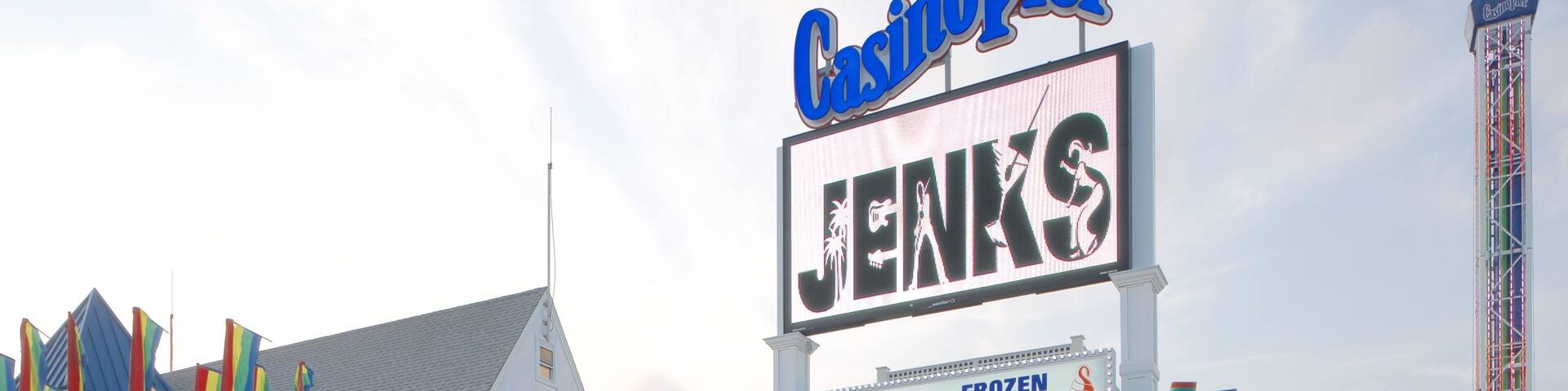 A boardwalk with various shops and a sign for 'Casino' and 'Jens'.