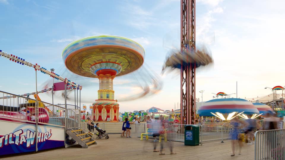 A carousel, a Ferris wheel, and a water ride at an amusement park.