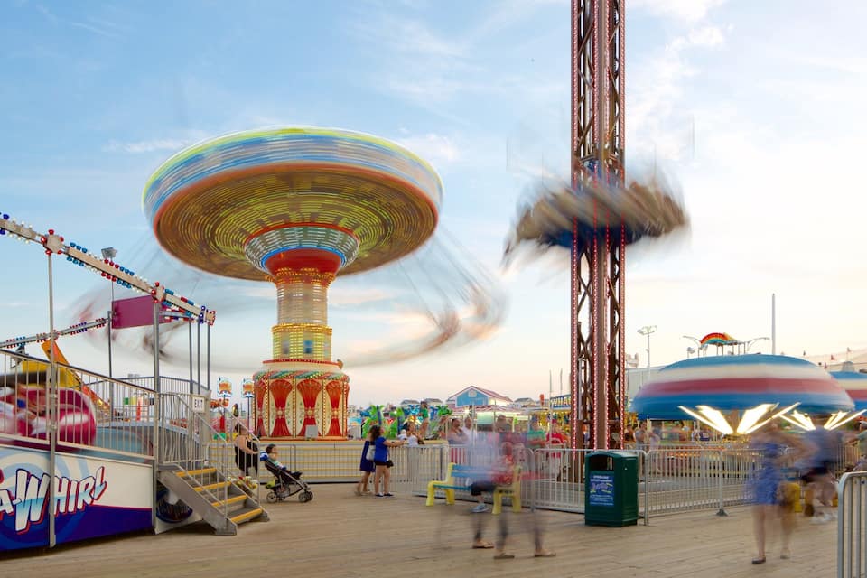 A carousel, a Ferris wheel, and a water ride at an amusement park.