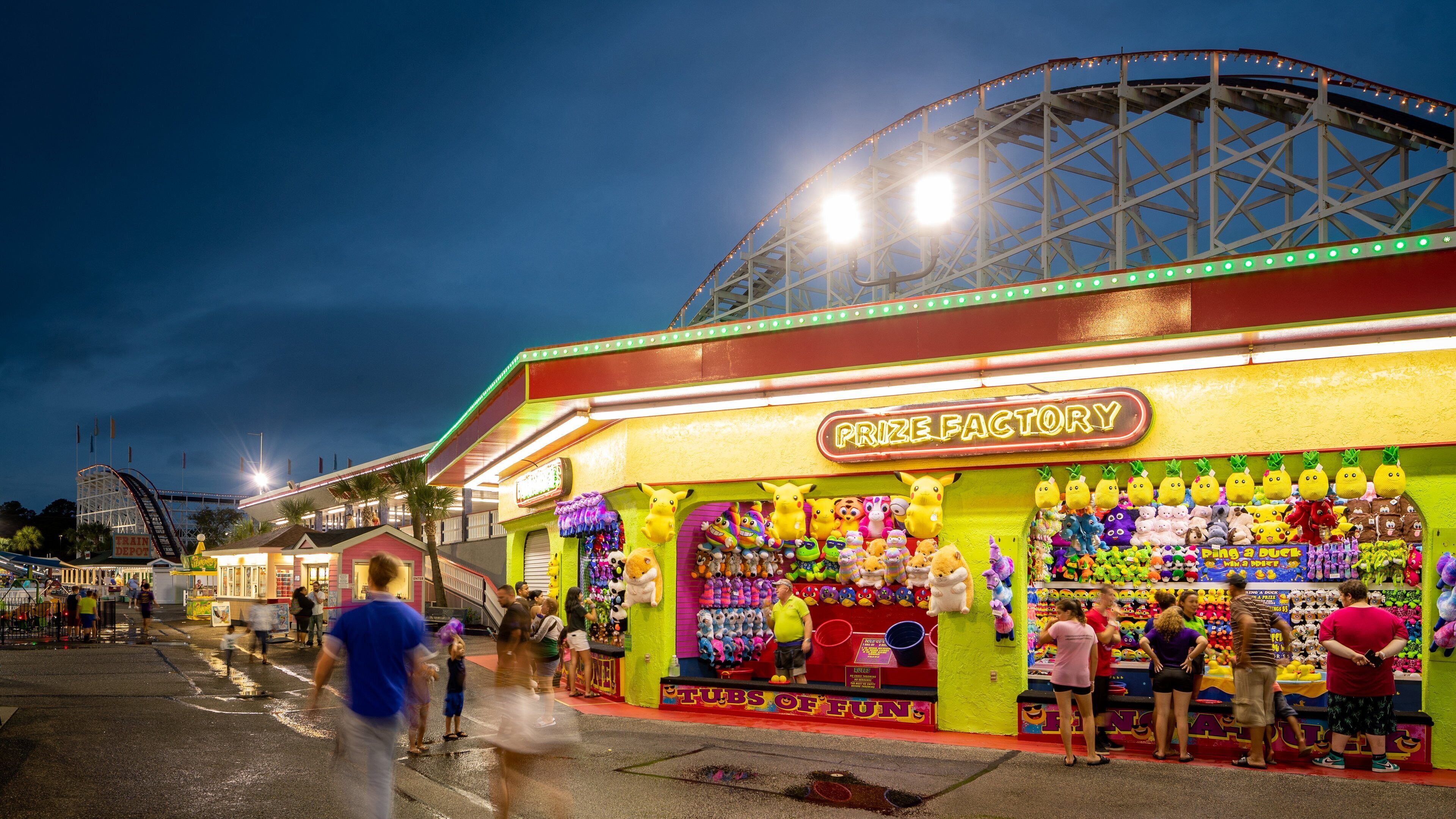 Family Kingdom Amusement Park featuring signage, night scenes and rides