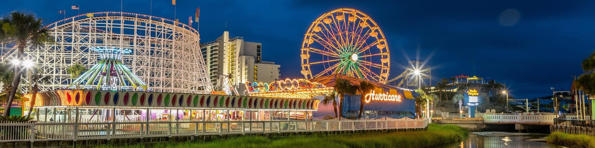 Family Kingdom Amusement Park which includes a river or creek, rides and night scenes