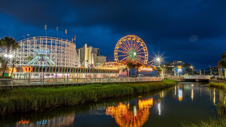 Family Kingdom Amusement Park which includes a river or creek, rides and night scenes