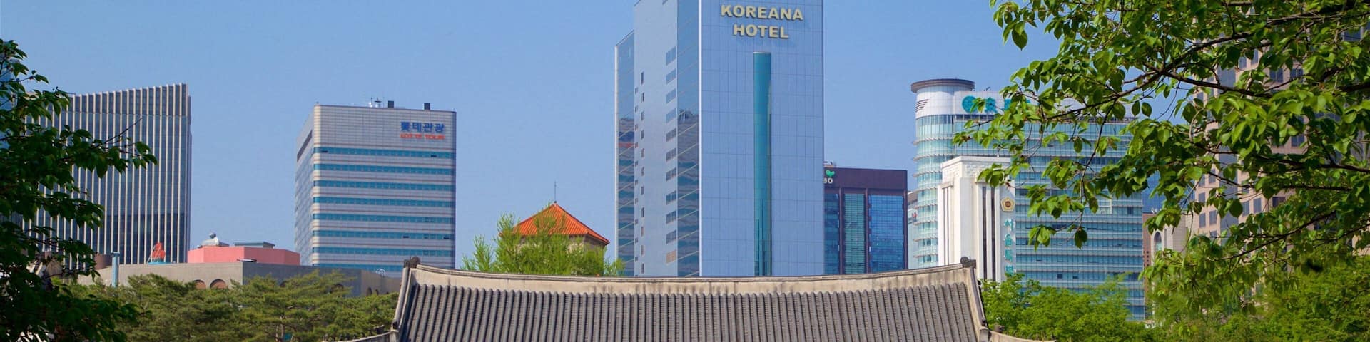 A traditional Korean building with a modern skyscraper in the background.
