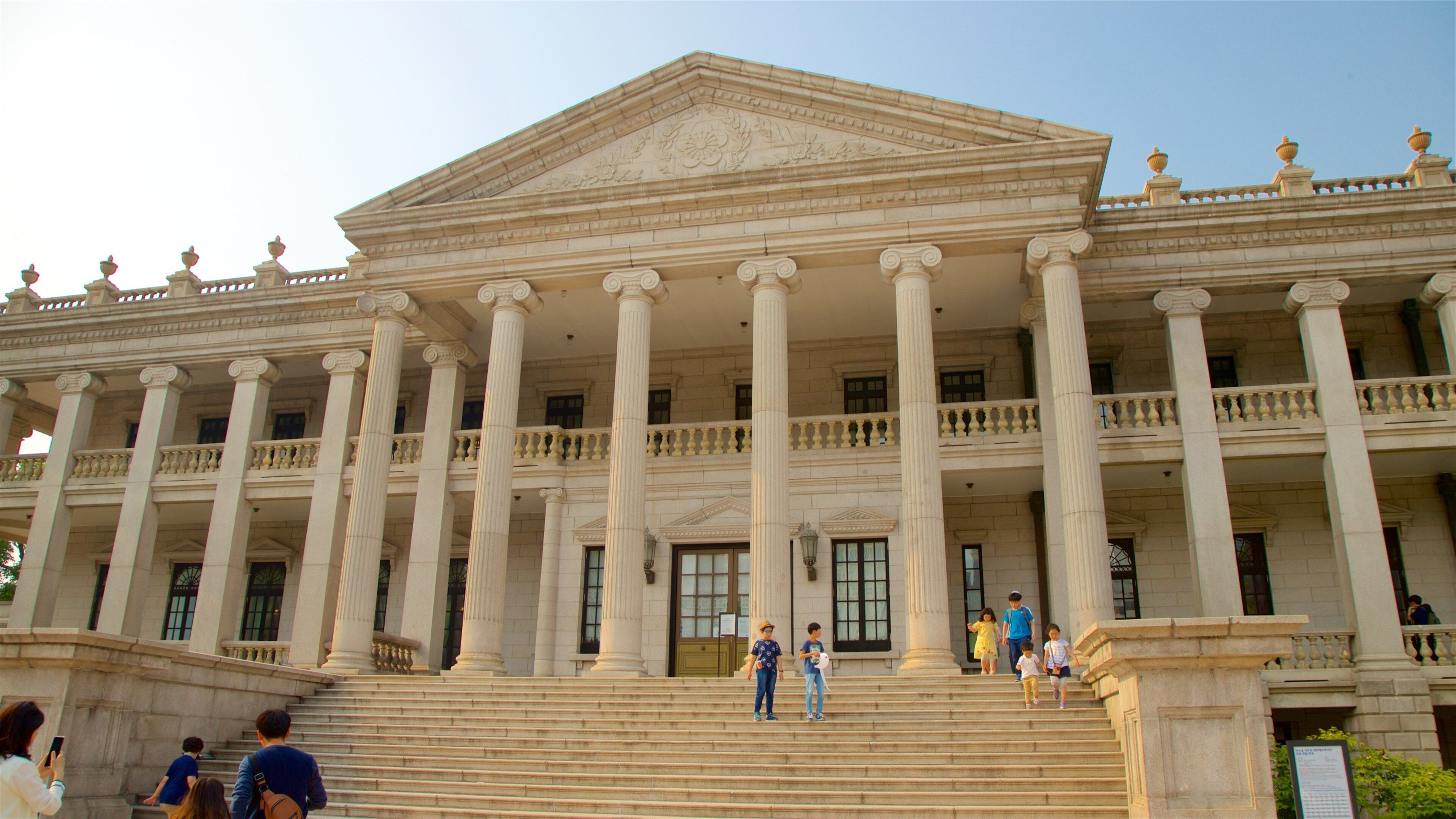 Deoksugung Palace which includes heritage architecture as well as a small group of people