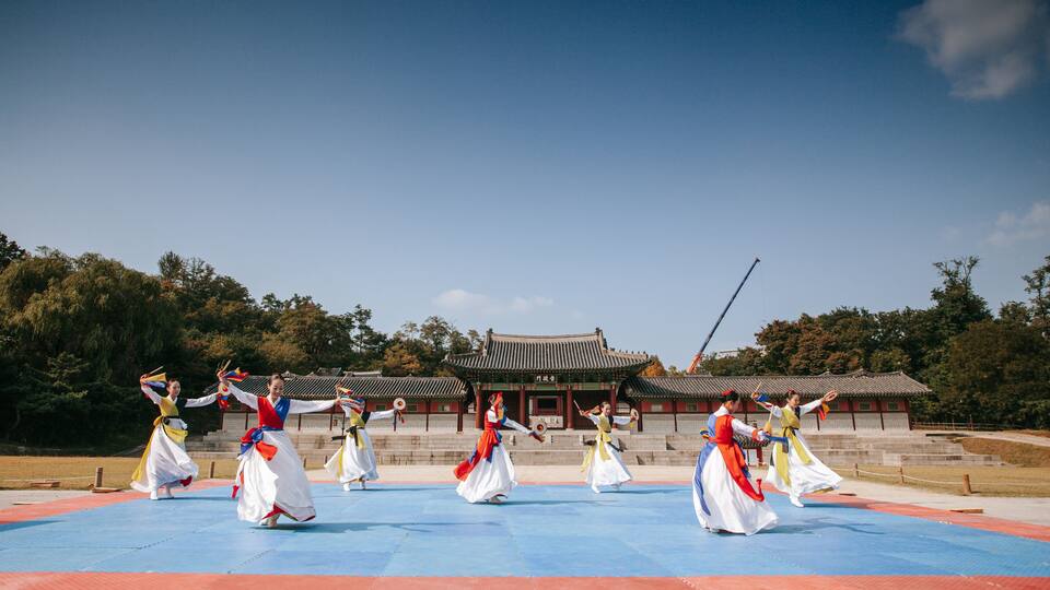 A traditional dance performance in front of a historic building.