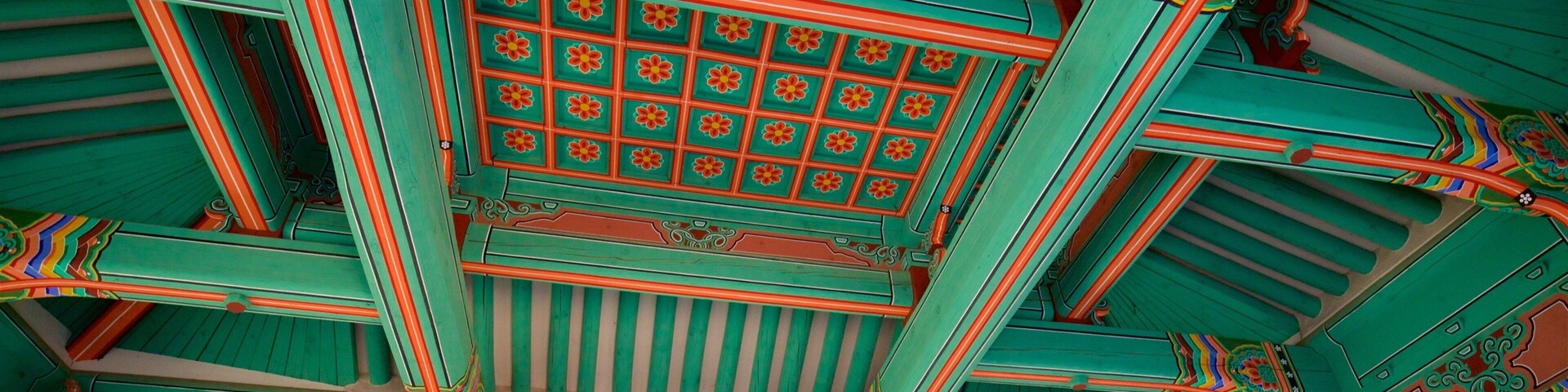 A traditional Korean roof with ornate wooden beams and colorful decorations.