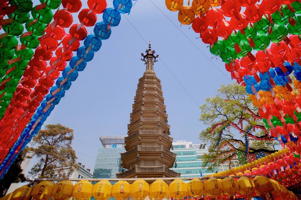 A pagoda surrounded by colorful lanterns.