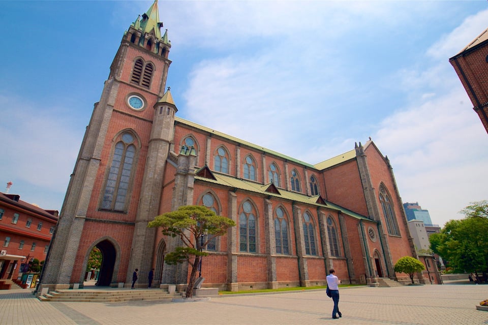 A large brick church with a clock tower and arched windows.