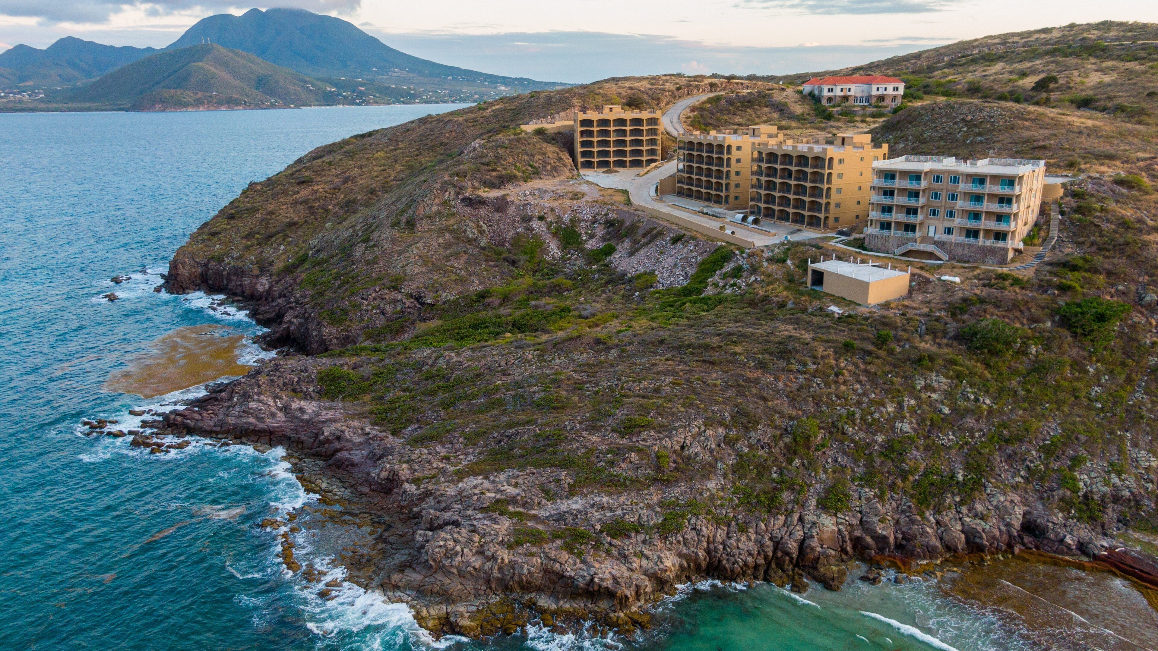 Turtle Beach which includes rugged coastline, landscape views and a coastal town