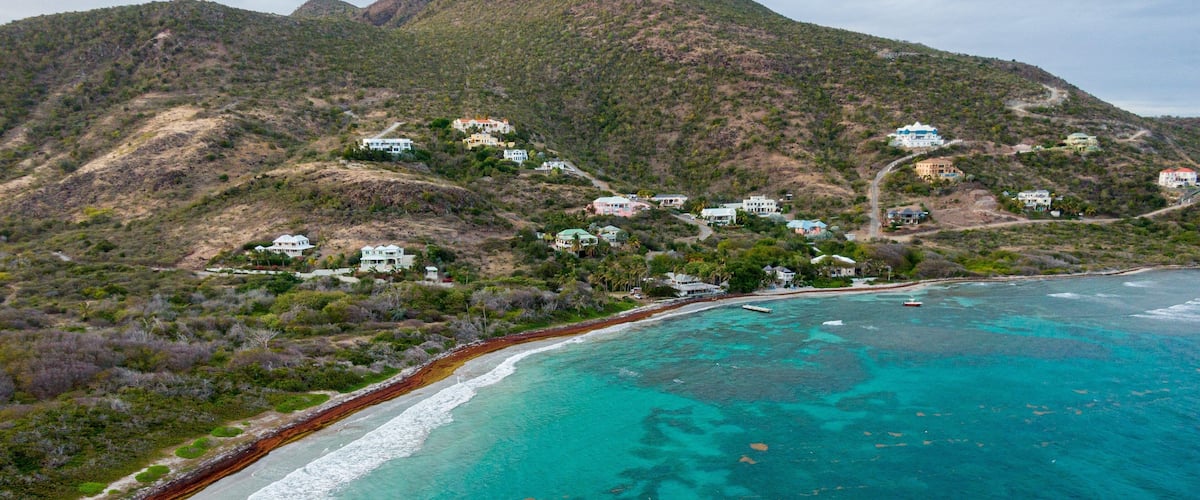 Turtle Beach which includes mountains, a coastal town and landscape views