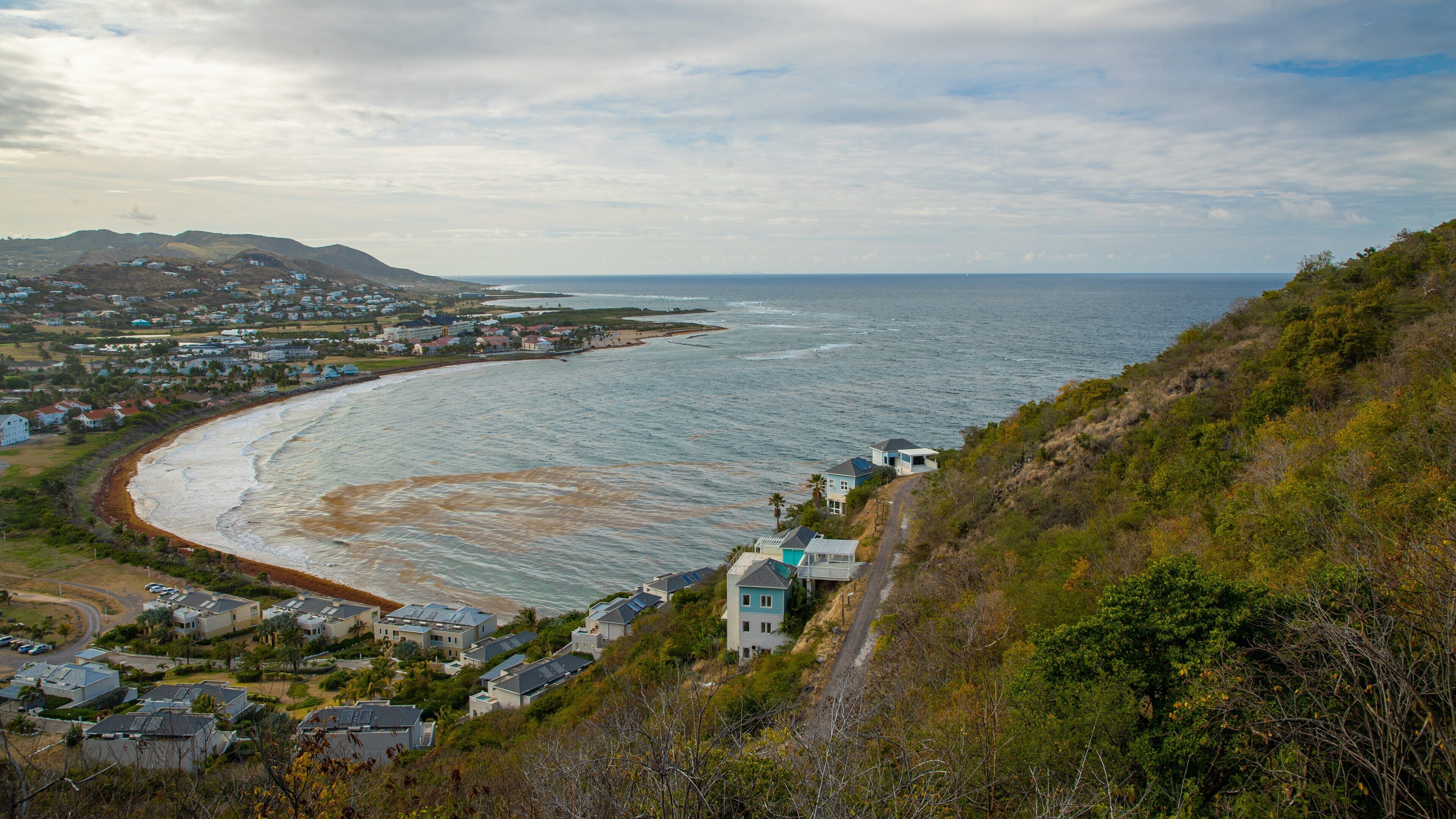 Timothy Hill which includes a coastal town, landscape views and a sunset