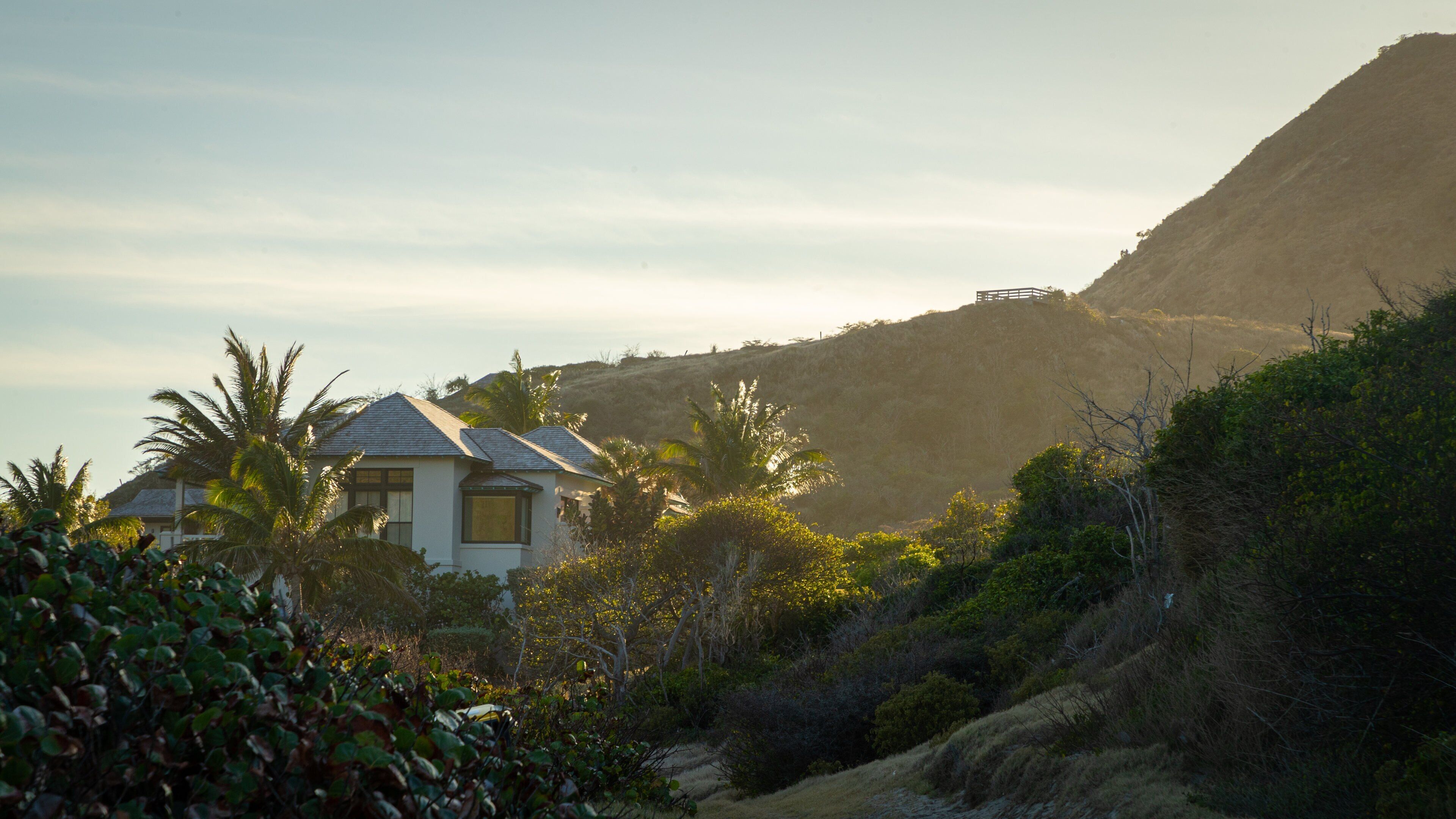 Sandy Bank Beach showing a coastal town, a sunset and a house