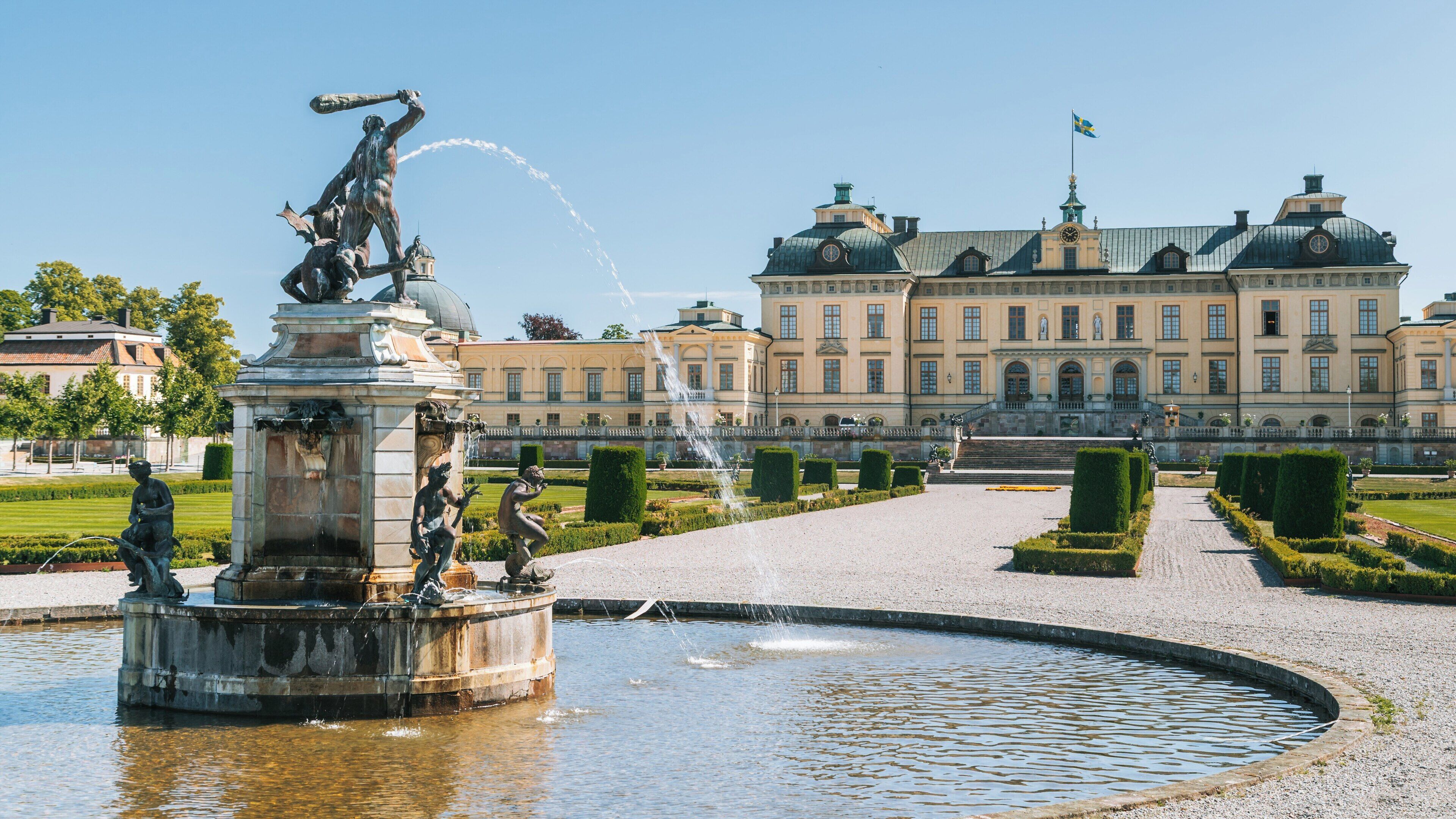 Drottningholm Palace showcases elegant architecture and stunning gardens in Stockholm County, Sweden, under a clear blue sky during a sunny day