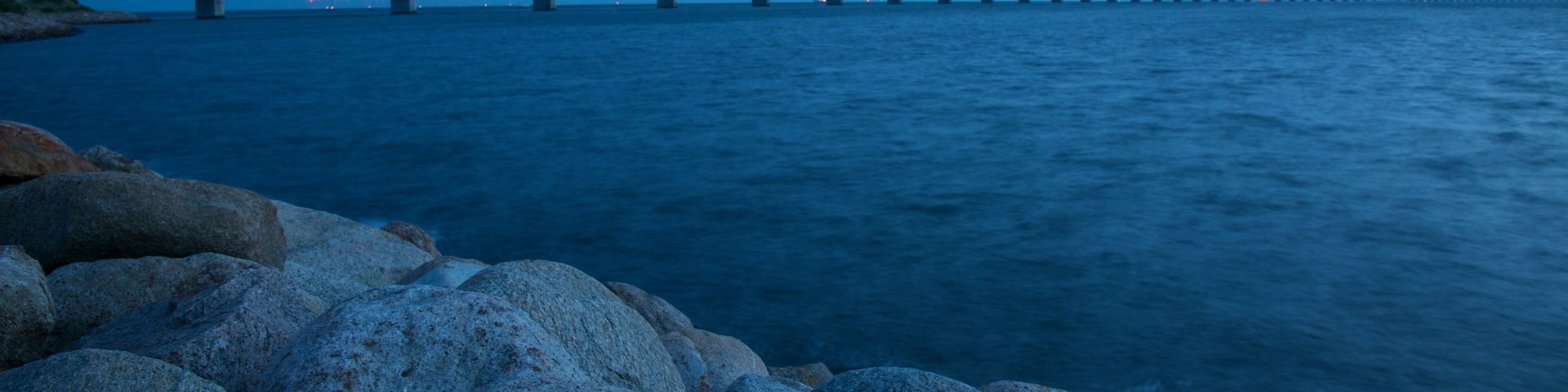 Oresund Bridge showing night scenes, a bridge and rocky coastline