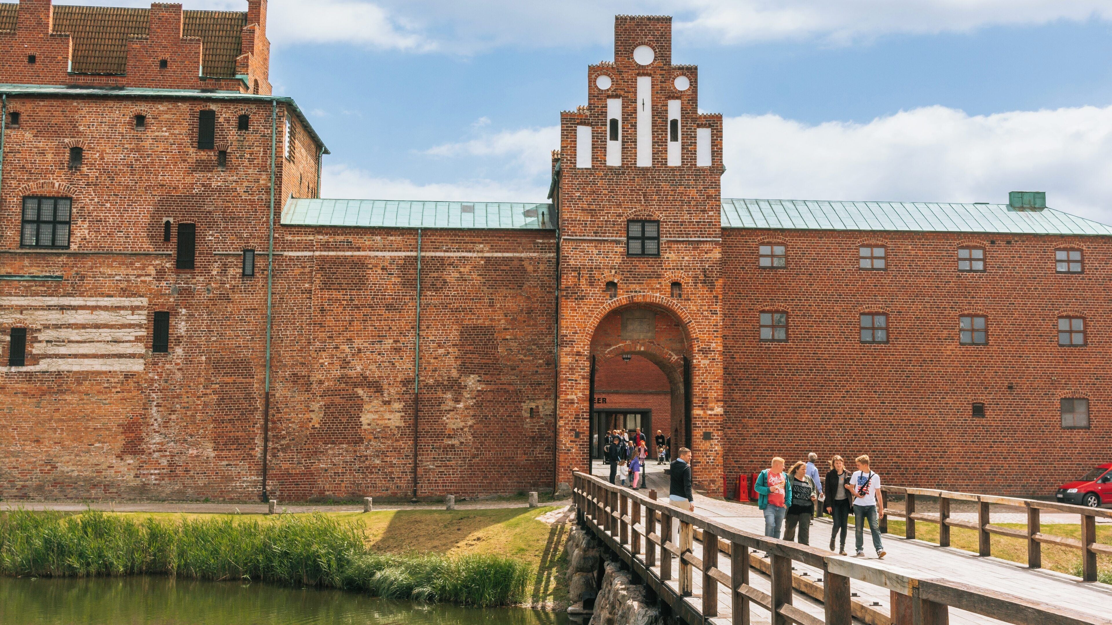 Explore historic Malmo Castle in Centrum, Malmö, Skåne County, Sweden, showcasing its impressive medieval architecture and visitor activity