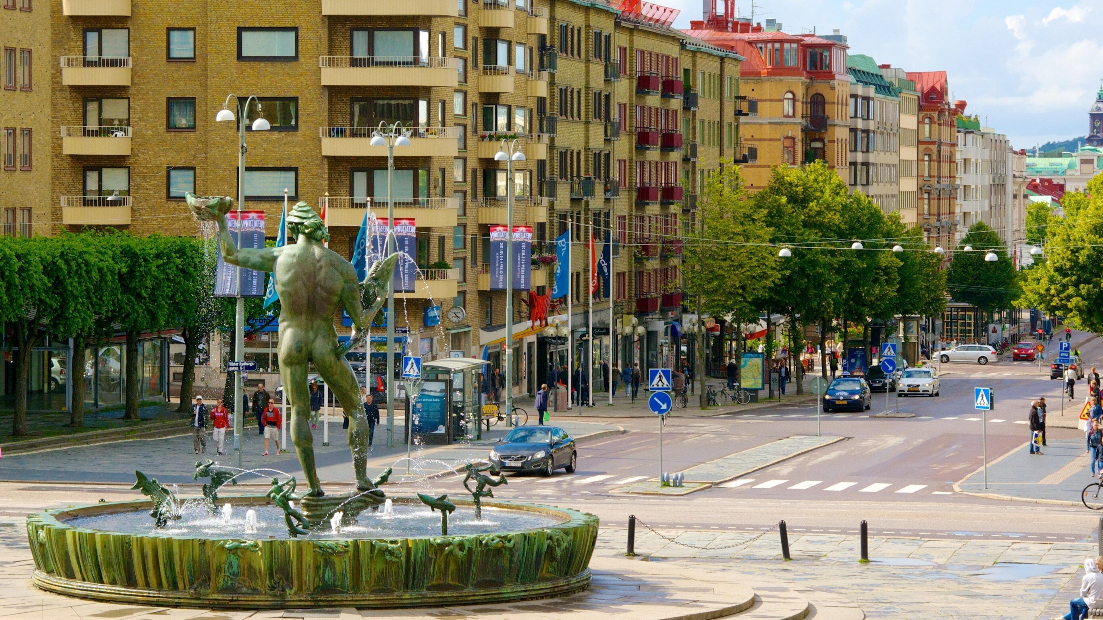 Poseidon Statue showing street scenes, a fountain and a city