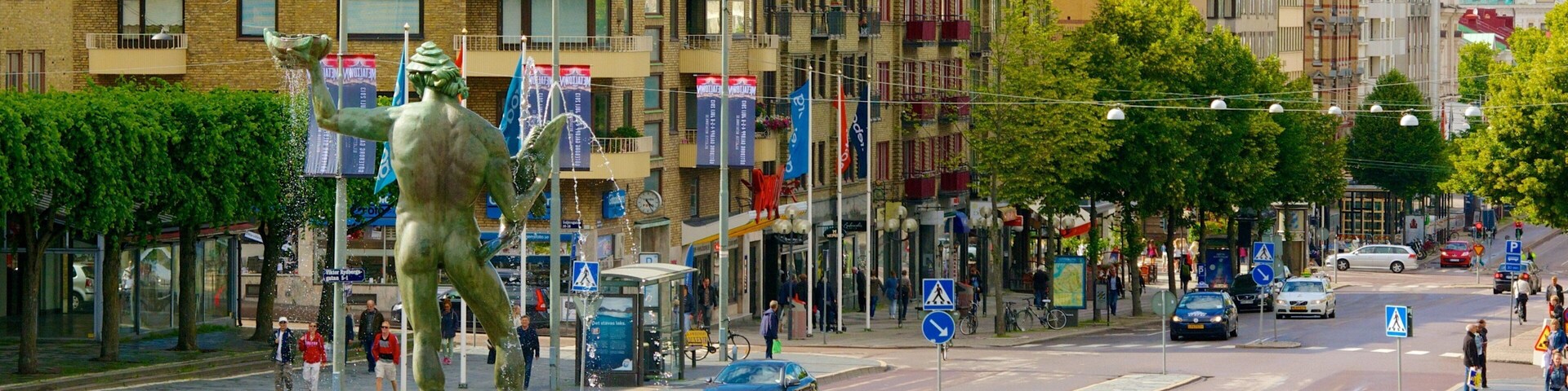 Poseidon Statue showing street scenes, a fountain and a city