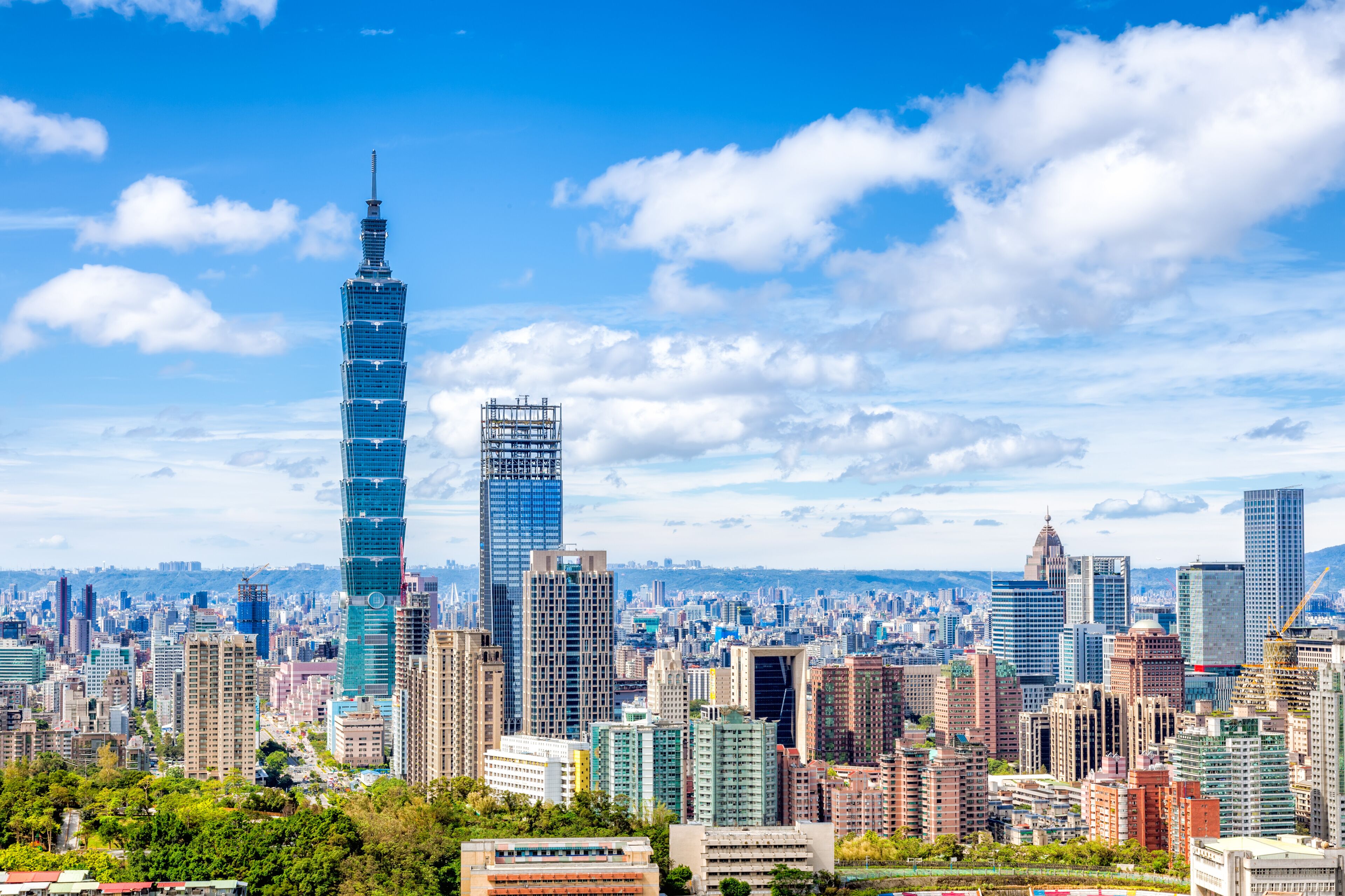 Cityscape of Taipei with skyscraper under dramatic clouds at blue sky in Taiwan