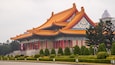 A traditional Chinese building with ornate golden roofs and red columns.