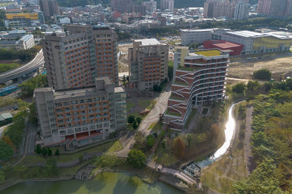 A high-rise residential area with modern architecture, a river, and a bridge.