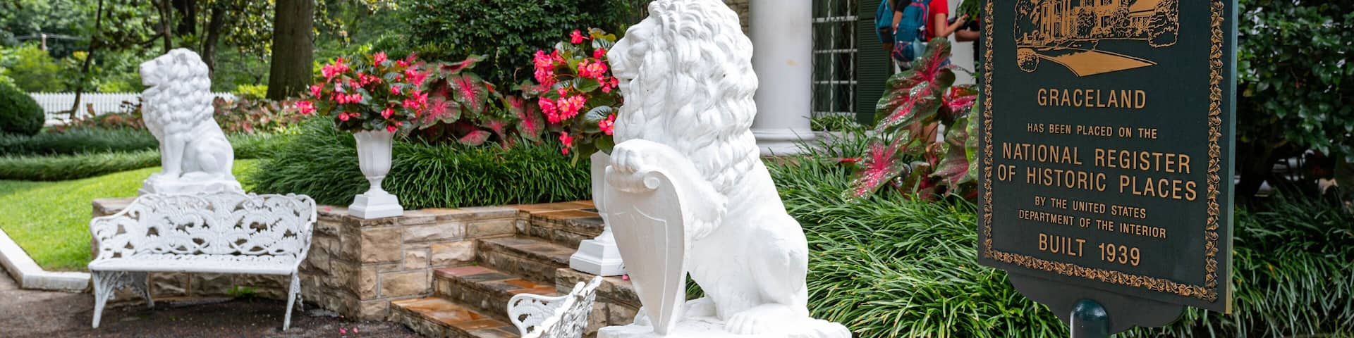A garden with a plaque about Graceland, a historic site built in 1939.