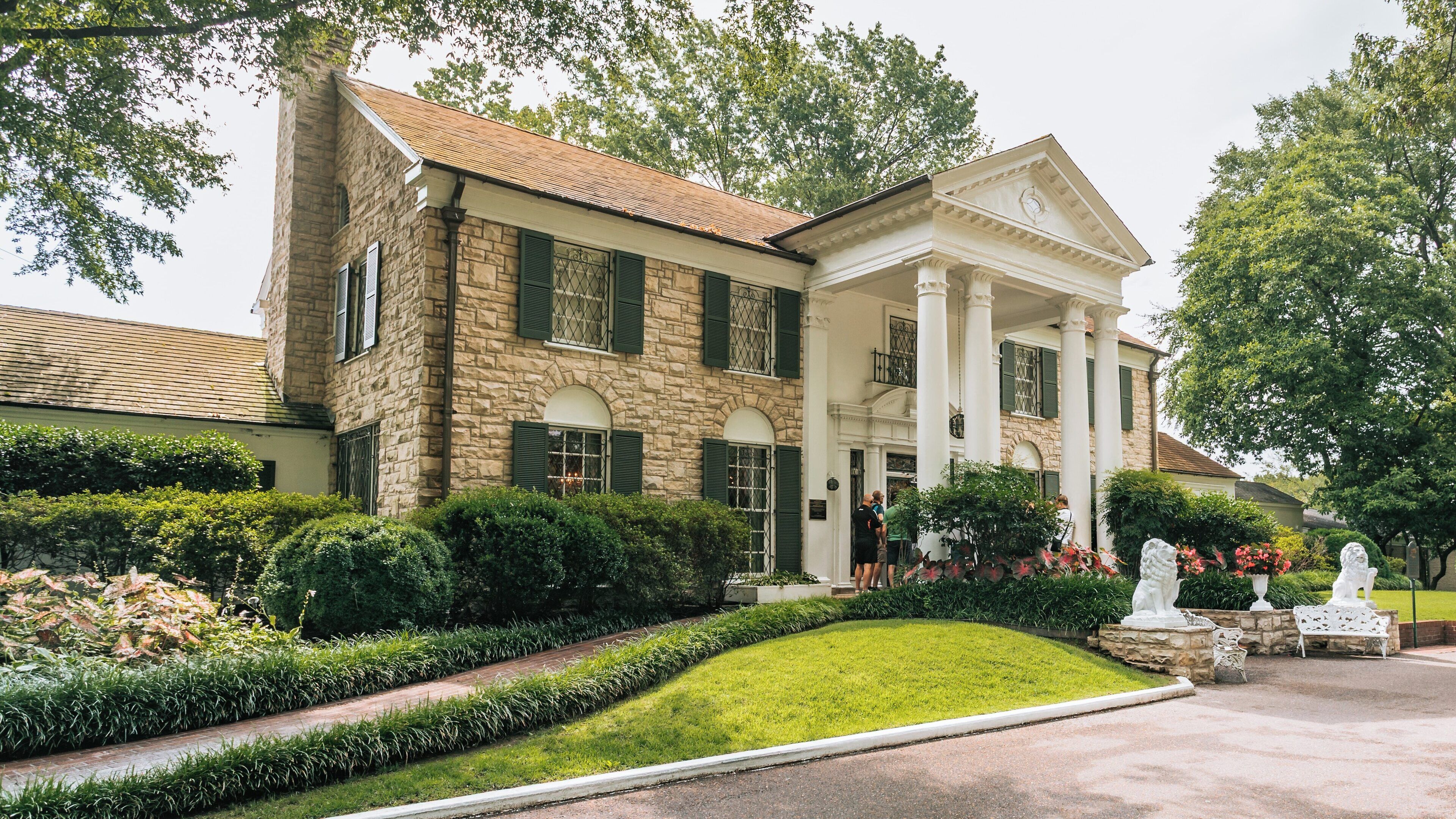 Visitors explore the historic Graceland estate in Whitehaven, Memphis, Tennessee, capturing the essence of its iconic architecture and lush surroundings