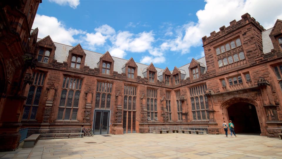 A historic building with large windows and a central archway.