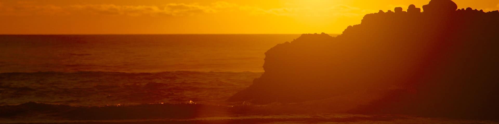 Piha Beach showing general coastal views and a sunset