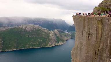 Preikestolen featuring a lake or waterhole, mountains and views
