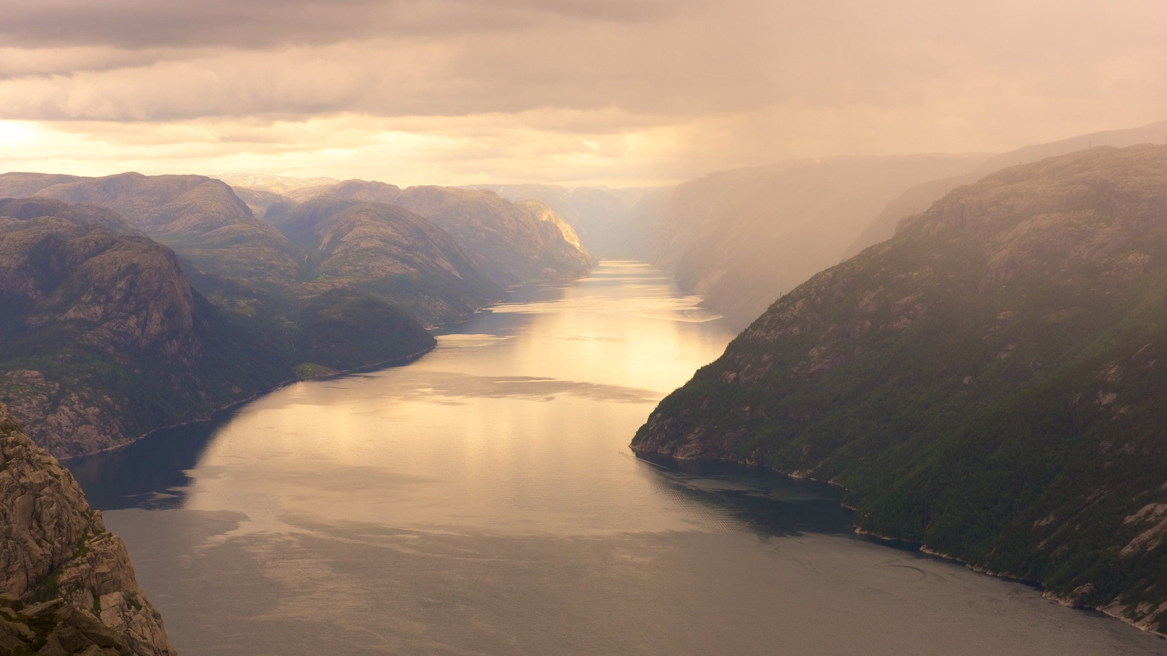 A river canyon with steep cliffs and a calm river.