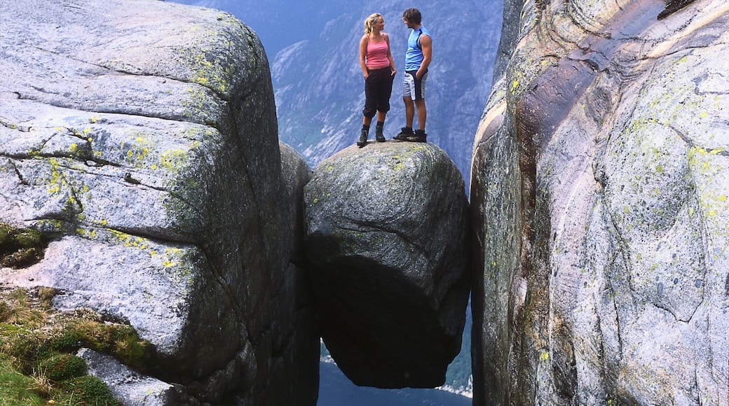 Kjerag featuring mountains and hiking or walking as well as a couple
