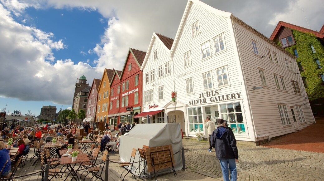 Bryggen which includes outdoor eating and a small town or village as well as a large group of people