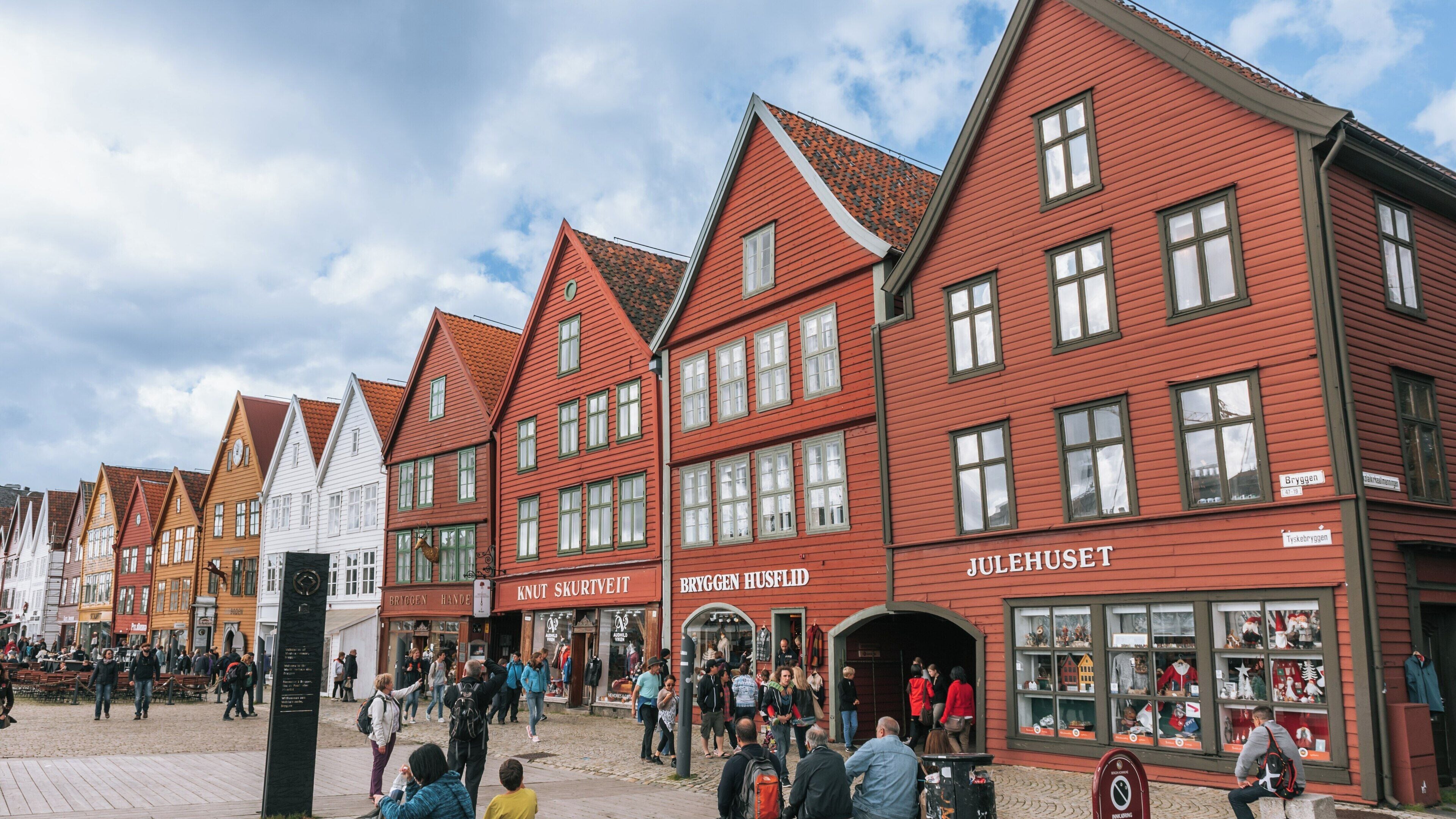 Colorful wooden buildings line the streets of Bryggen in Bergen City Centre showcasing Norwegian architecture and vibrant culture