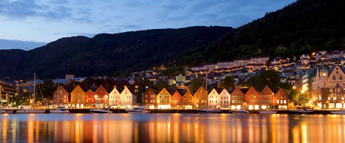 A waterfront town with traditional houses and boats docked along the shore.