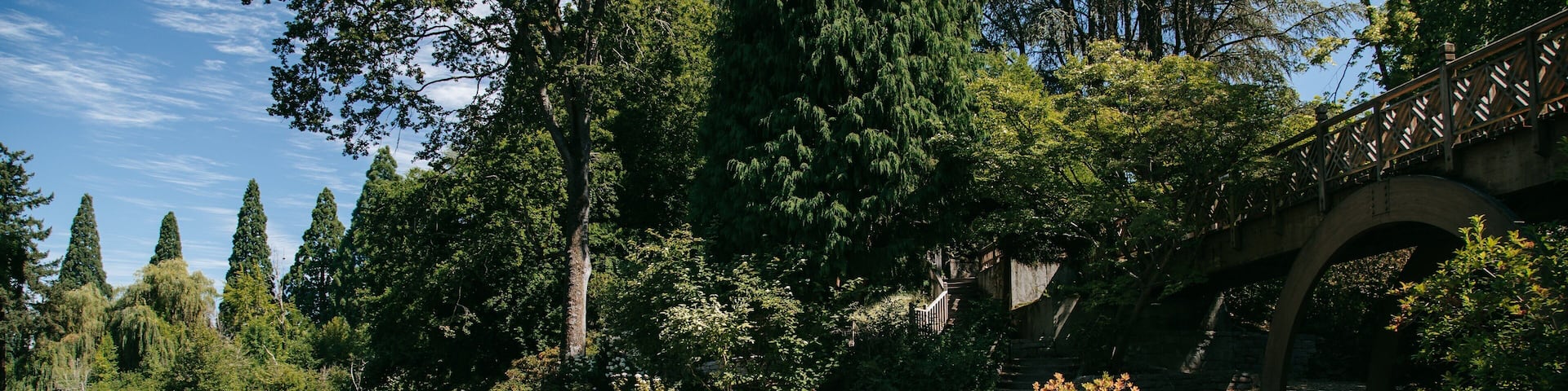 Crystal Springs Rhododendron Garden which includes a pond and bird life as well as a family