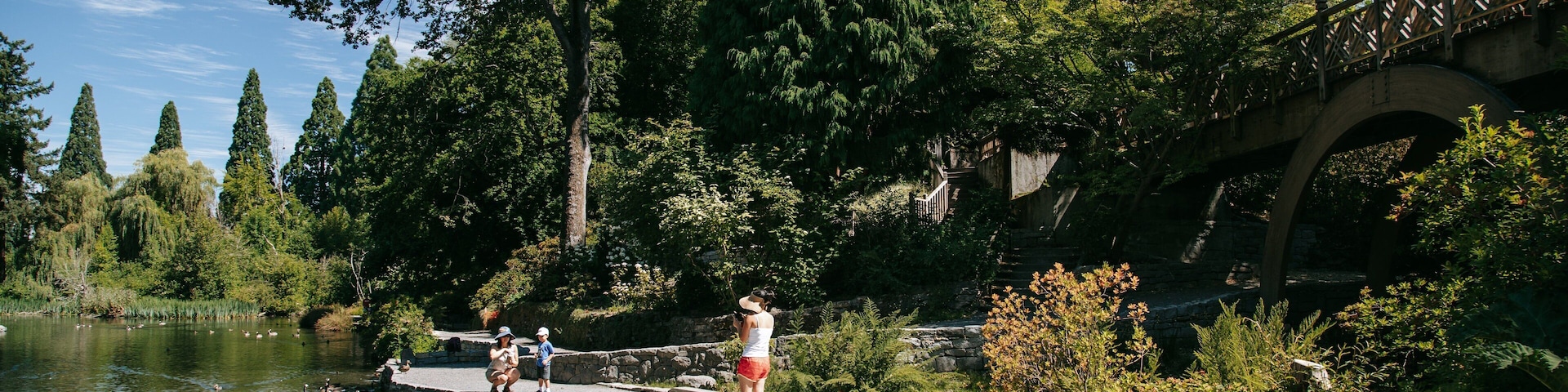 Crystal Springs Rhododendron Garden which includes a pond and bird life as well as a family
