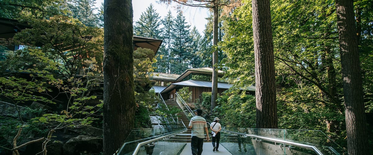 Portland Japanese Garden featuring a bridge, a garden and forest scenes
